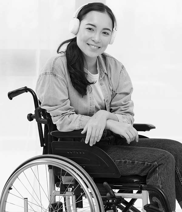 young lady in a wheelchair with headphones on